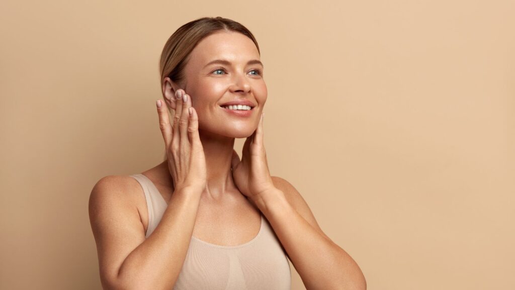 A woman touching her jaw in discomfort, illustrating TMJ pain, often treated with Botox.